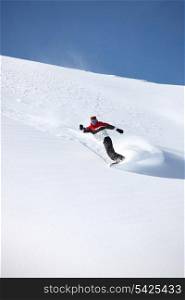 Snowboarder spaying snow