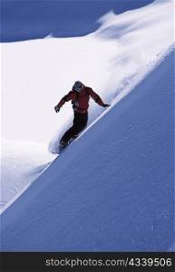 Snowboarder turning a slope