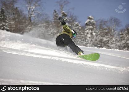 snowboarder woman enjoy freeride on fresh powder snow on beautiful sunny winter morning