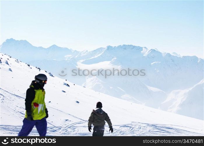 snowboarders on the mountain backdrop