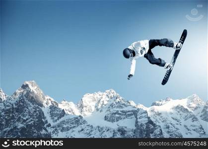 Snowboarding. Snowboarder making jump high in clear sky