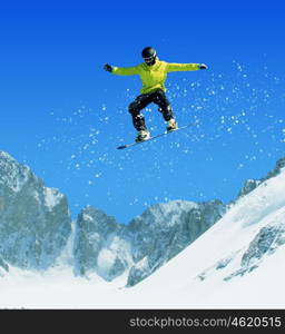 Snowboarding. Snowboarder making jump high in clear sky