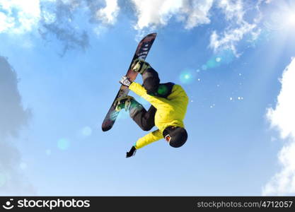 Snowboarding. Snowboarder making jump high in clear sky