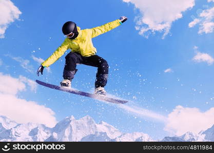 Snowboarding. Snowboarder making jump high in clear sky