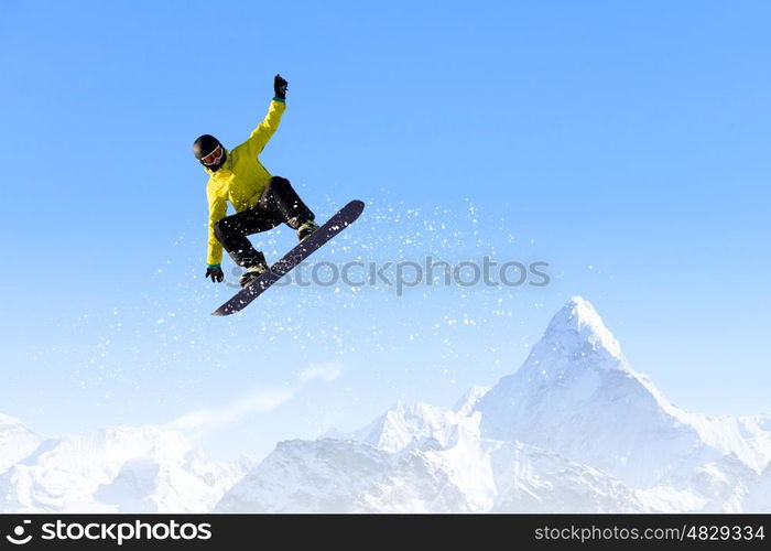 Snowboarding. Snowboarder making jump high in clear sky