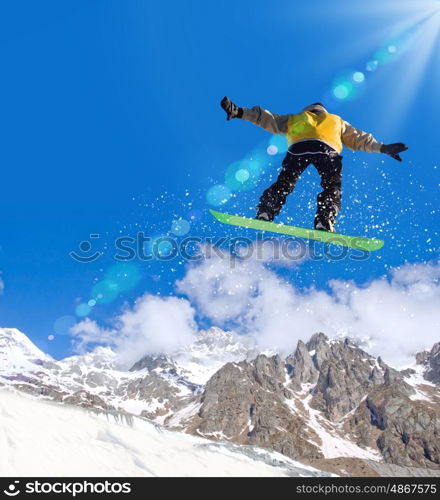 Snowboarding. Snowboarder making jump high in clear sky