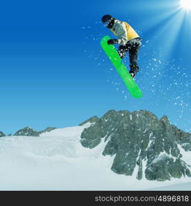 Snowboarding. Snowboarder making jump high in clear sky