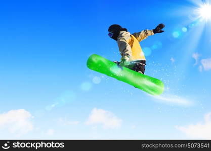 Snowboarding. Snowboarder making jump high in clear sky