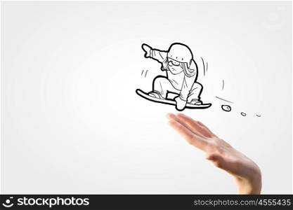 Snowboarding sport. Close up of human hand and caricature of jumping snowboarder