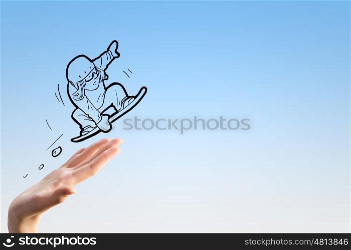 Snowboarding sport. Close up of human hand and caricature of jumping snowboarder