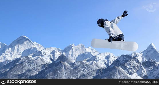 Snowboarding sport. Snowboarder making high jump in clear blue sky