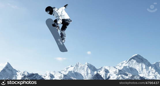 Snowboarding sport. Snowboarder making high jump in clear blue sky