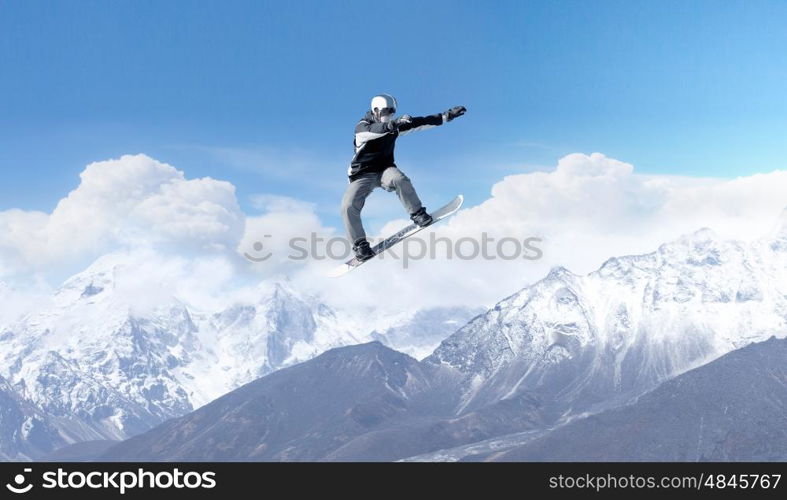 Snowboarding sport. Snowboarder making high jump in clear blue sky