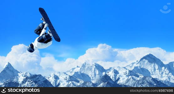 Snowboarding sport. Snowboarder making high jump in clear blue sky