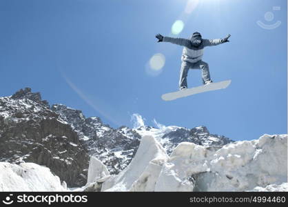 Snowboarding sport. Snowboarder making high jump in clear blue sky