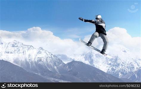 Snowboarding sport. Snowboarder making high jump in clear blue sky