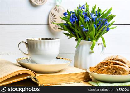snowdrops in a vase on a table on a white background, Easter