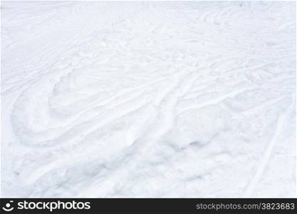 snowfield with ski runs and paths in snow in winter day