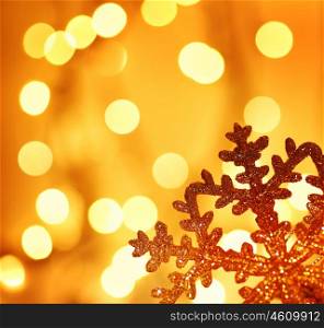 Snowflake background border golden Christmas tree ornament and holiday decoration over abstract defocus lights