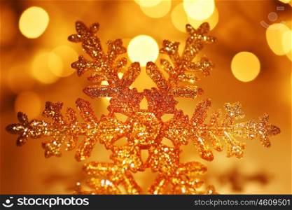 Snowflake background golden Christmas tree ornament and holiday decoration over abstract defocus lights