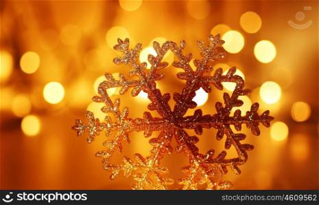 Snowflake background golden Christmas tree ornament and holiday decoration over abstract defocus lights