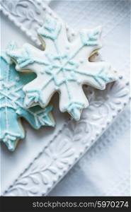 Snowflake cookies on white pastel background