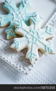 Snowflake cookies on white pastel background