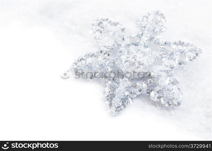 snowflake decoration in white snow isolated