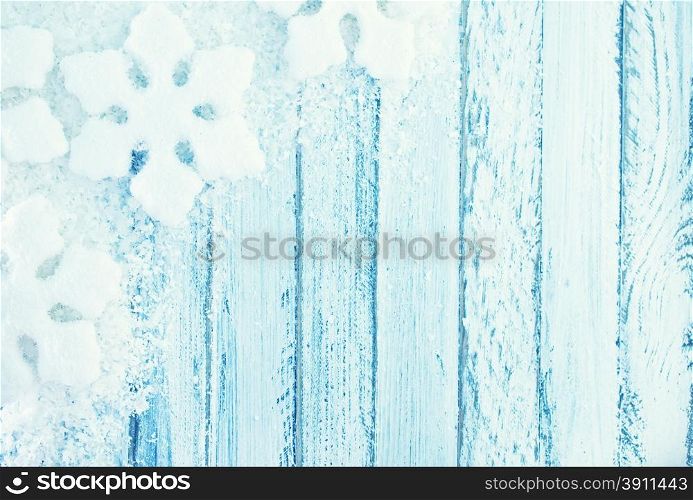 snowfolk and snow on white wooden background