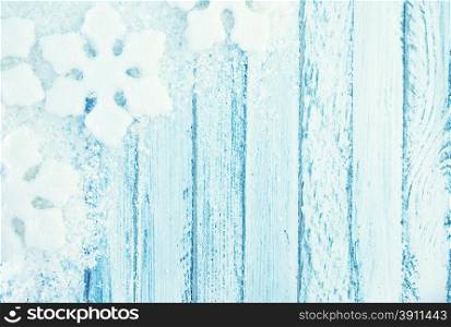 snowfolk and snow on white wooden background