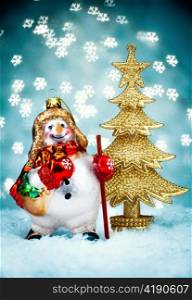 Snowman and a Christmas fur-tree with Blue Holiday Background.