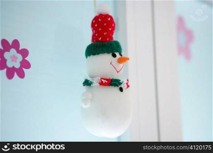 snowman hanging on the white window