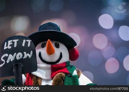 snowman standing in winter christmas, Merry Christmas and happy New Year greeting winter bokeh background