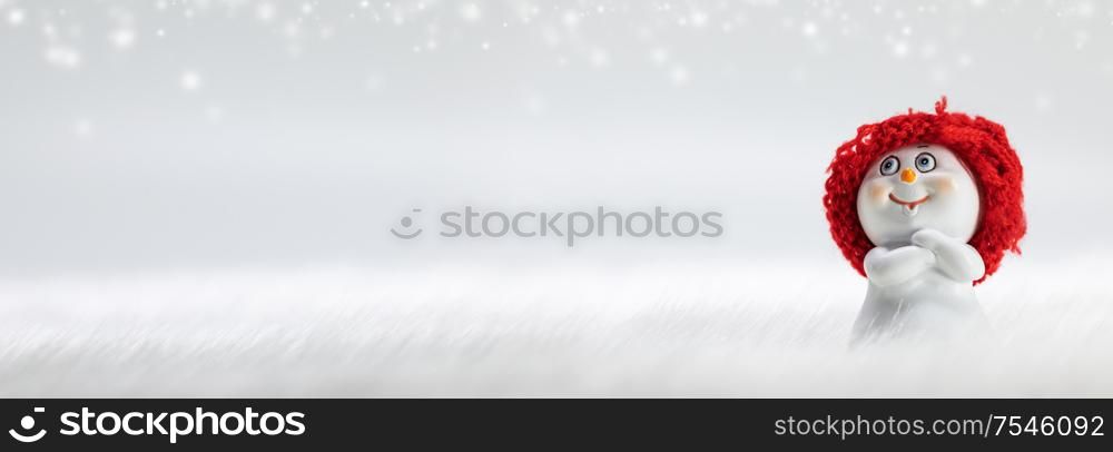 Snowman toy on frozen snow and bokeh lights winter background. Snowman toy on winter background
