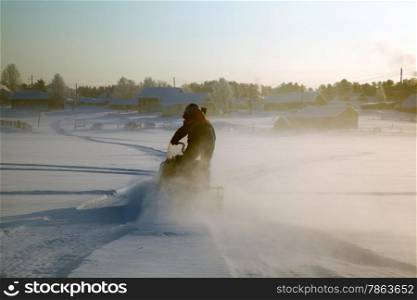 Snowmobile at full speed. Winter landscape.