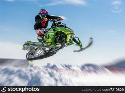 snowmobile rider jumping through snow