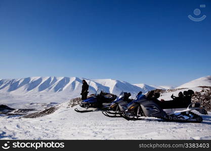 Snowmobiles in a barren winter landscape, Svalbard, Norway
