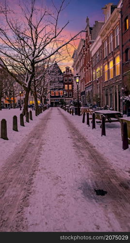 Snowy Amsterdam in winter in the Netherlands Europe at sunset