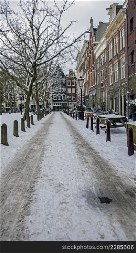 Snowy Amsterdam in winter in the Netherlands Europe at sunset