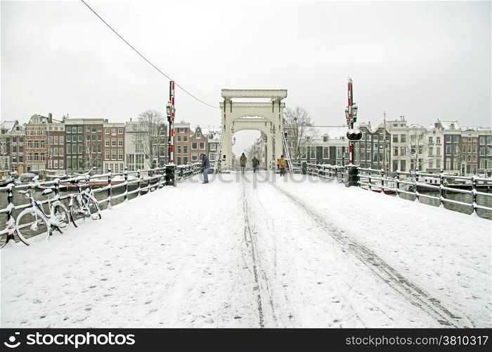Snowy Amsterdam with the Thiny bridge in the Netherlands
