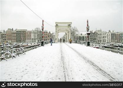 Snowy Amsterdam with the Thiny bridge in the Netherlands