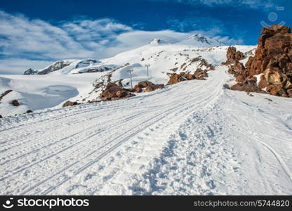 Snowy blue mountains in clouds. Winter ski resort