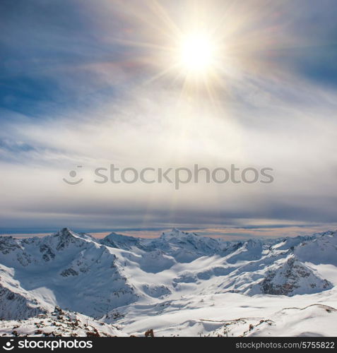 Snowy blue mountains in clouds. Winter ski resort