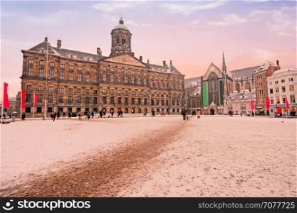 Snowy Damsquare in Amsterdam the Netherlands in winter at sunset