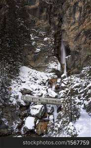 Snowy landscape with bridge and a waterfall on the background