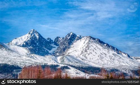 Snowy Lomnicky peak on a sunny day with a blue sky in High Tatras, Slovakia, Europe