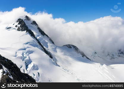 Snowy mountain peak. Mountain landscape with snow and clear blue sky