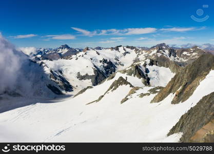 Snowy mountain peak. Mountain landscape with snow and clear blue sky