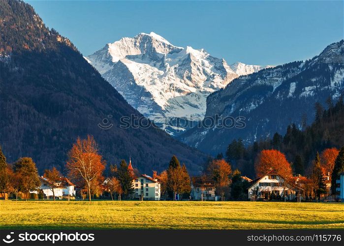 snowy mountain peak with village in autumn and spring, Europe travel destination