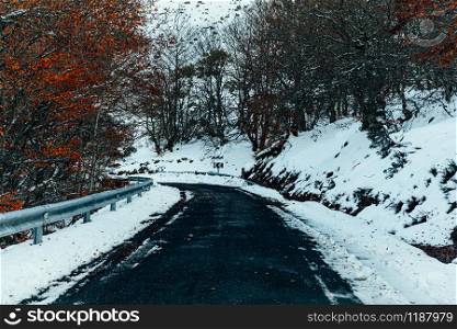 Snowy mountain road at sunrise in spain.
